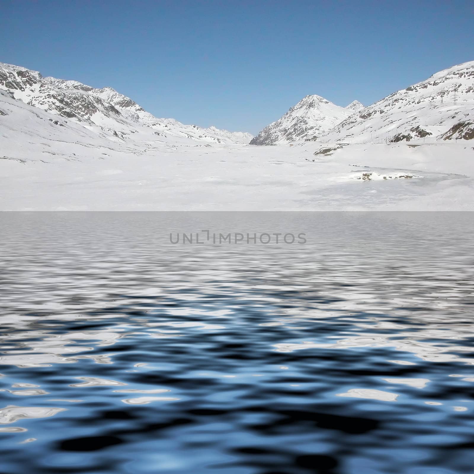 Mountains with snow reflected in lake water