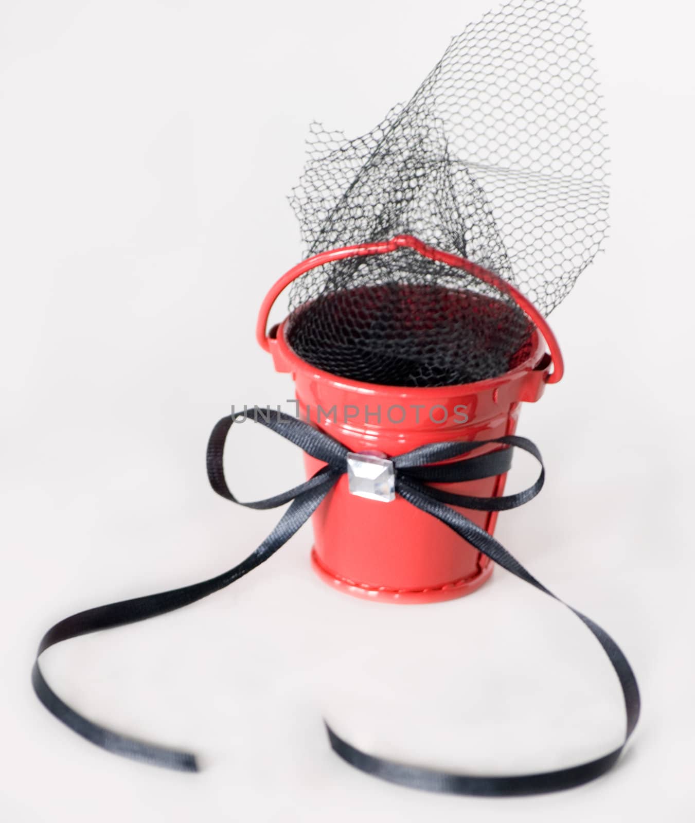 Red bucket with black ribbon and tulle.