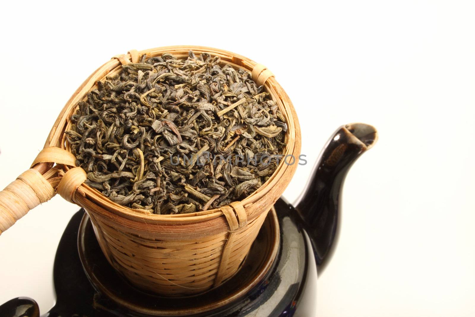 Green tea in strainer by carterphoto