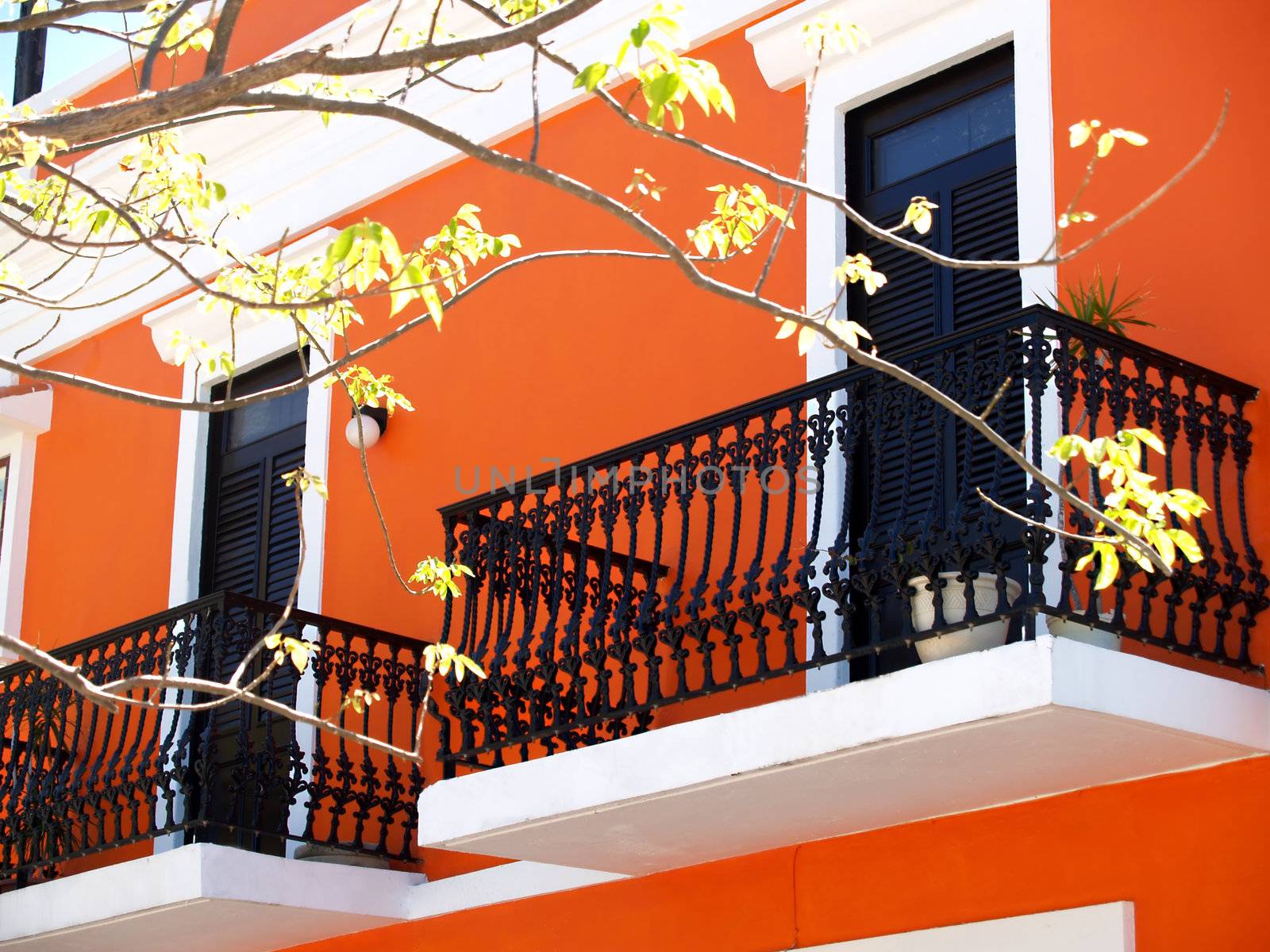 Balcony with iron rails and orange exterior