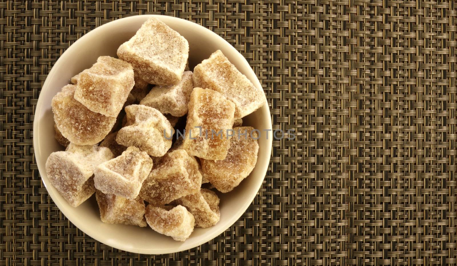 Candied ginger in a white bowl.