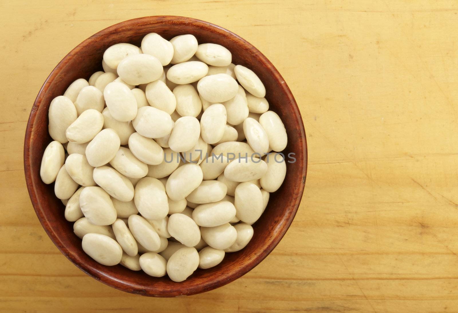 Organic Great Northern beans in a wooden bowl.