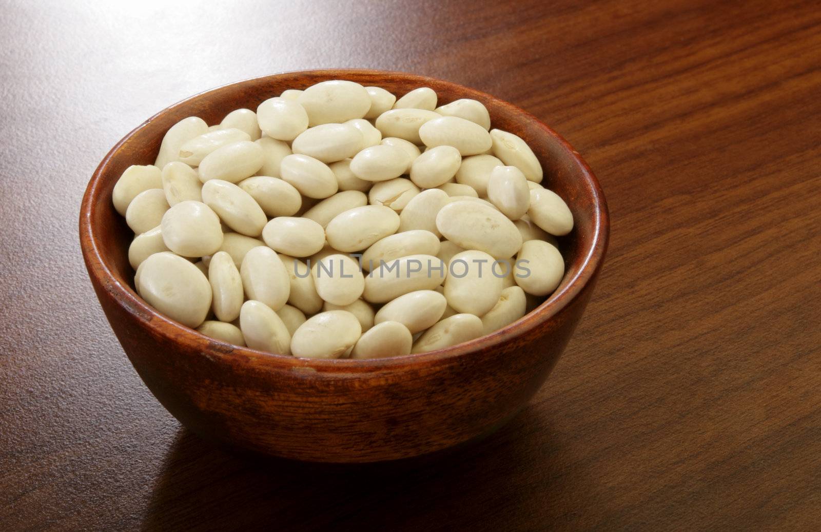 Organic Great Northern beans in a wooden bowl.