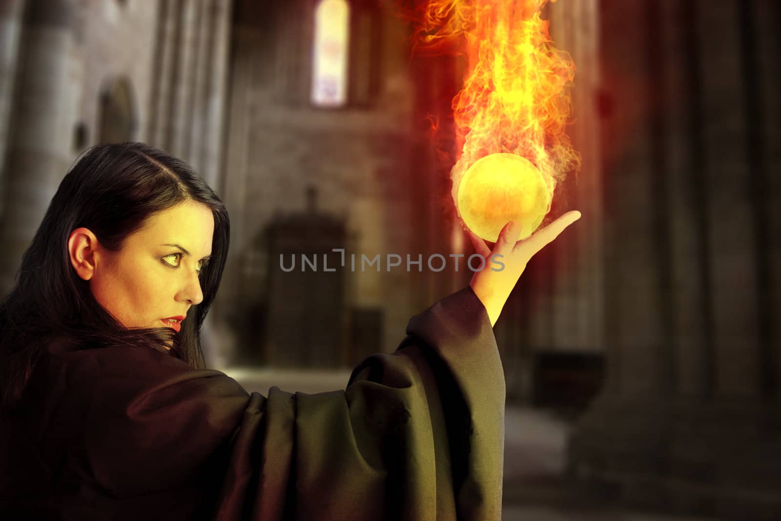 Young beautiful girl with fire sphere, sorcerer