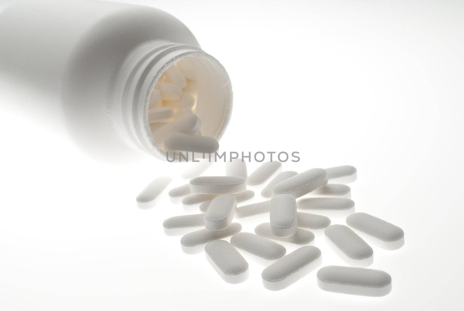 High key shot of prescription pills and white bottle