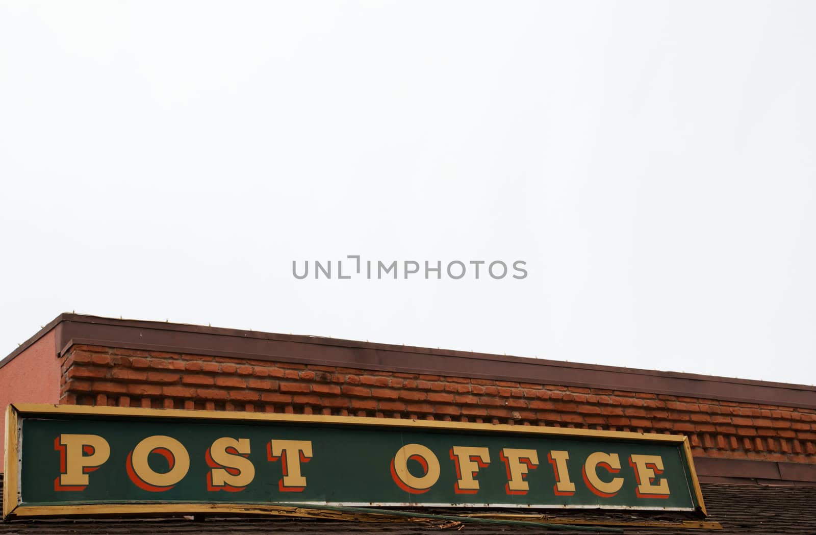 Old post office sign with cloudy overcast sky