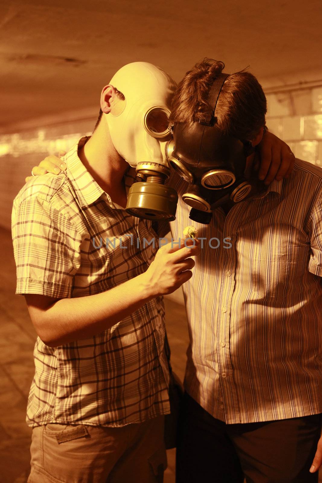 Two men in gas masks with flower in the tunnel