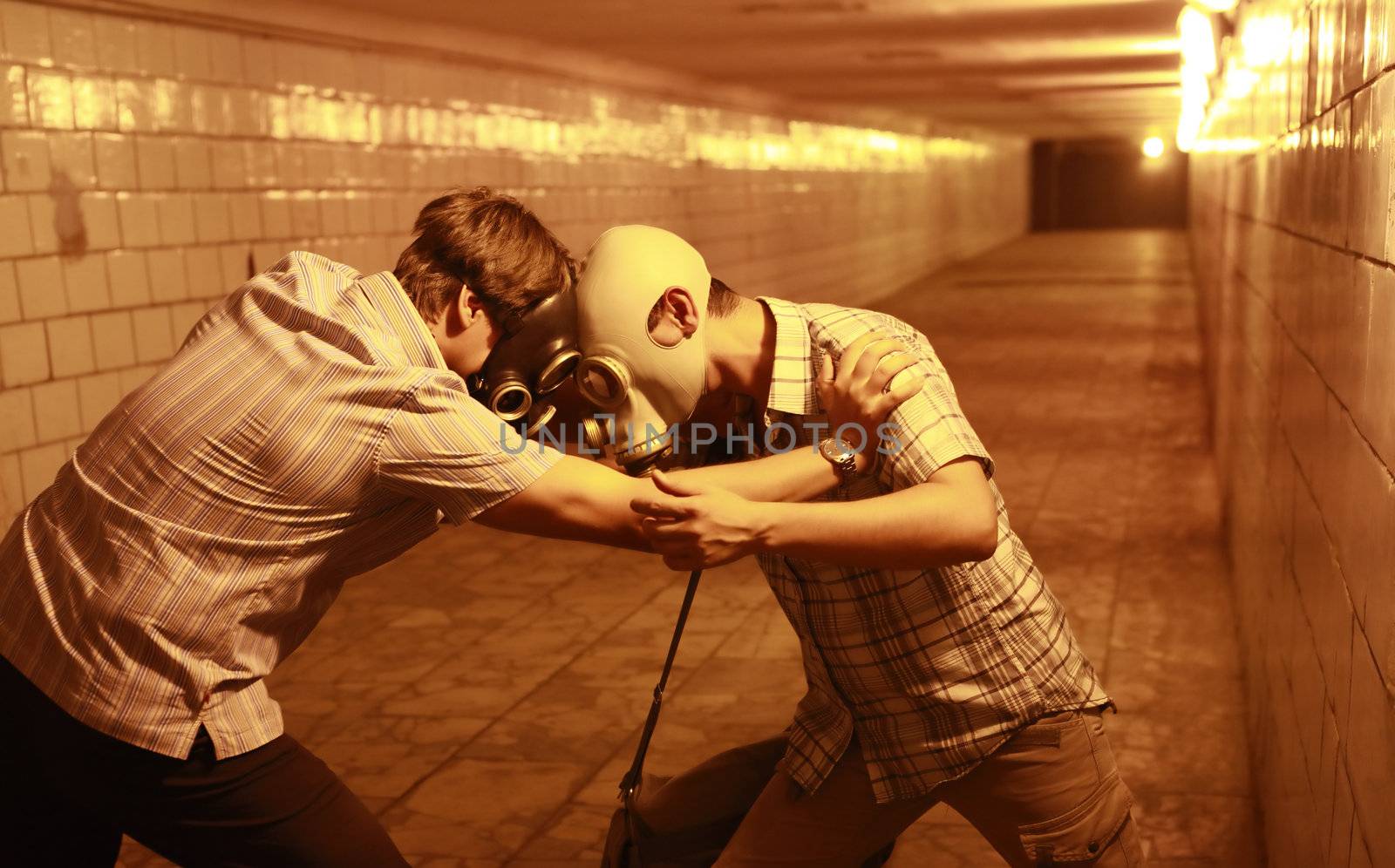 Two men in gas masks in the tunnel
