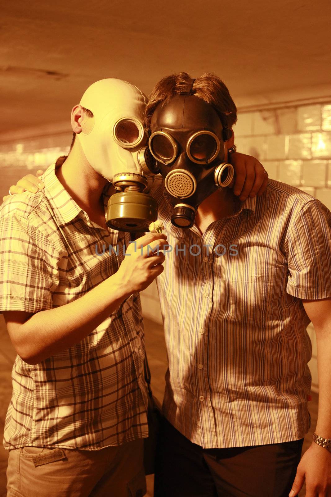 Two men in gas masks with flower in the tunnel