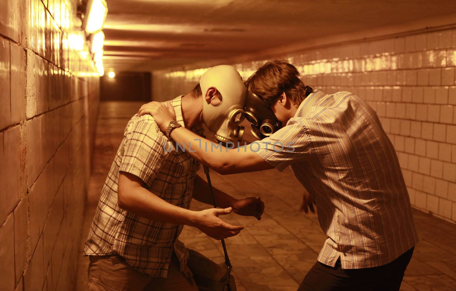 Two men in gas masks in the tunnel