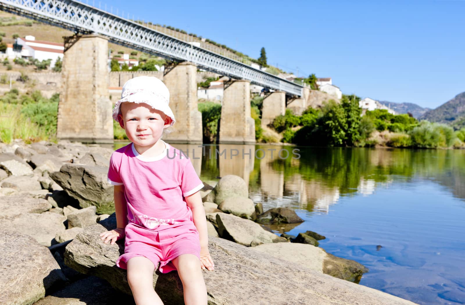 little girl sitting at railway viaduct in Douro Valley, Portugal by phbcz
