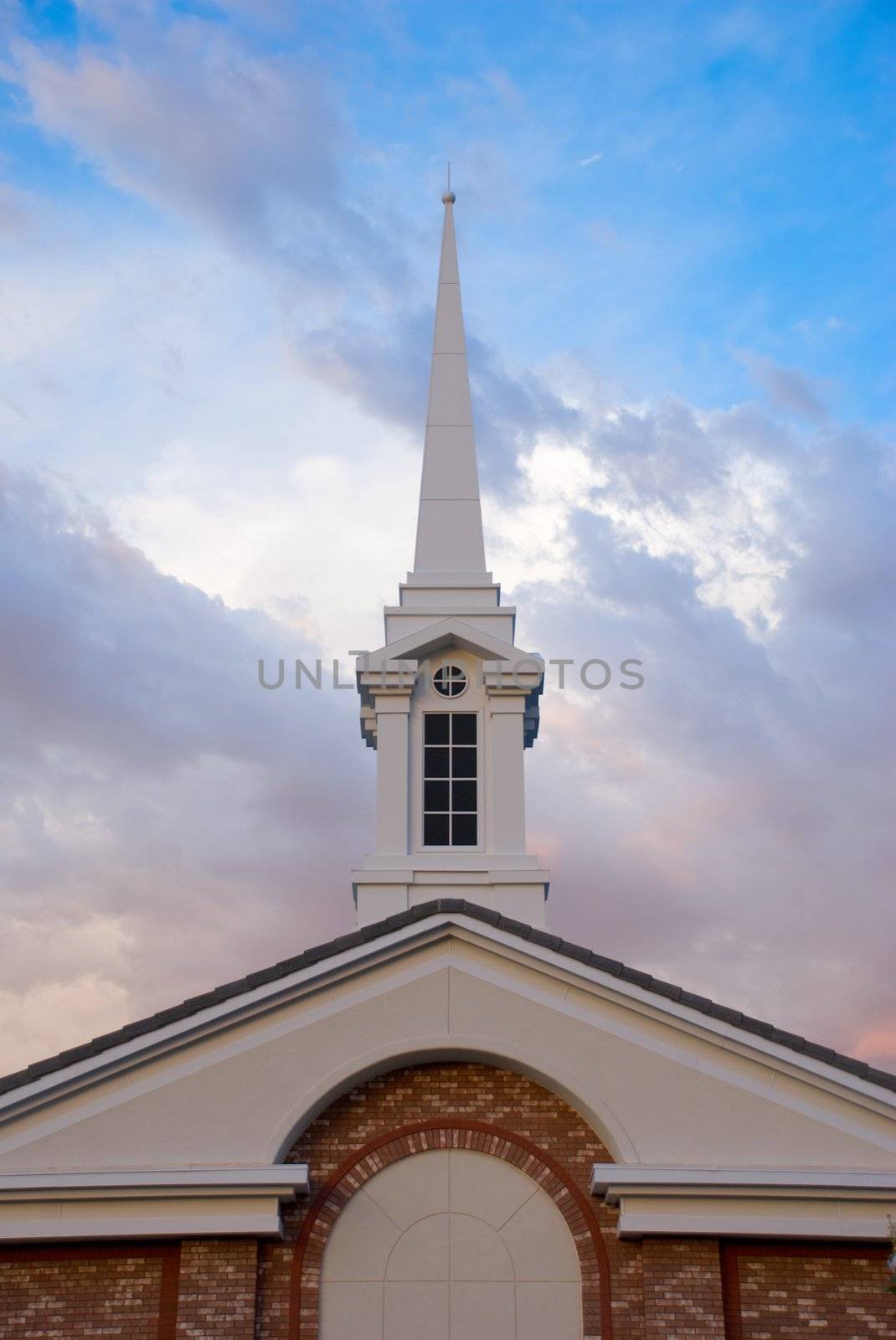 White Spire on Church Building with Dramatic Sky