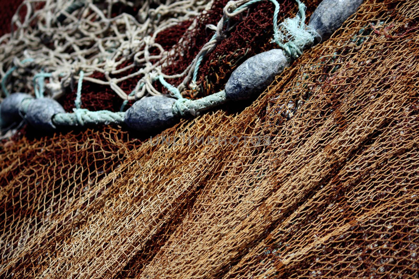 Close view of some fishing net and led weights on the docks.