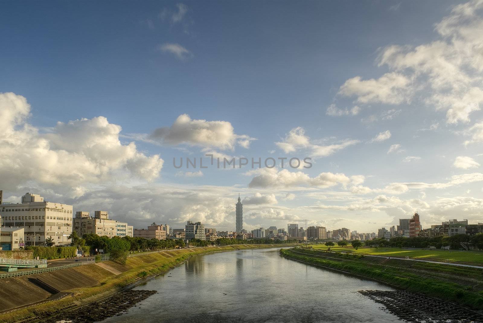 City skyline in Taipei with famous landmark 101 skyscraper and reflection on river in afternoon in Taiwan.