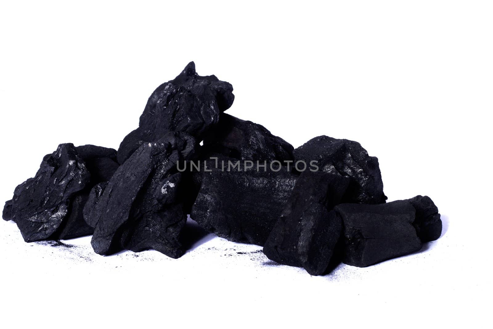 Close up view of some black coal isolated on a white background.