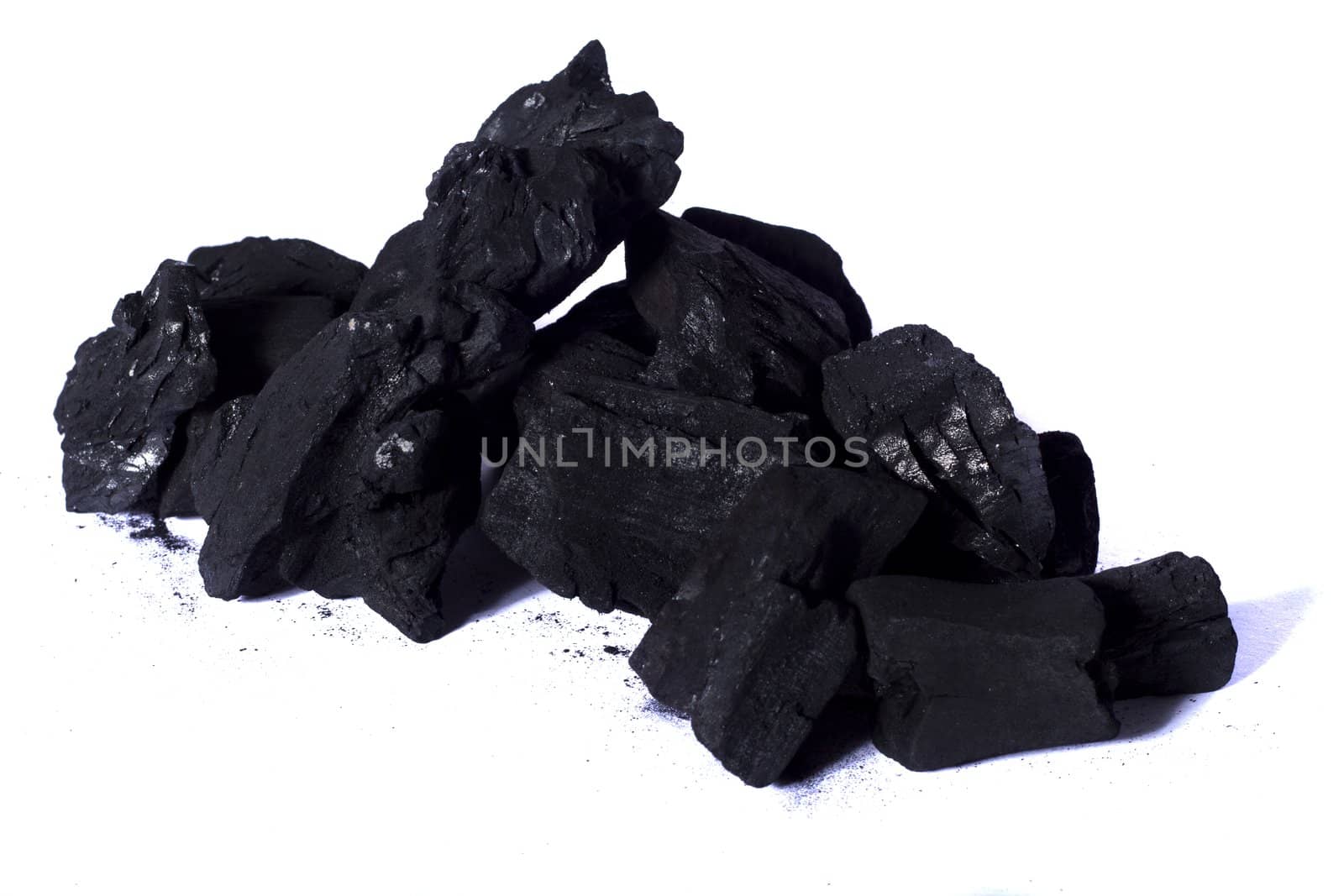 Close up view of some black coal isolated on a white background.