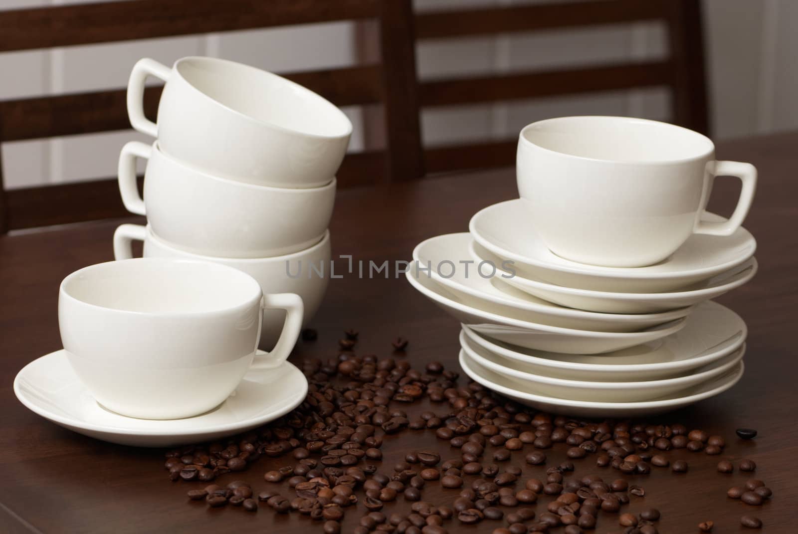 Cups for coffee with coffee grains on a dark wooden table