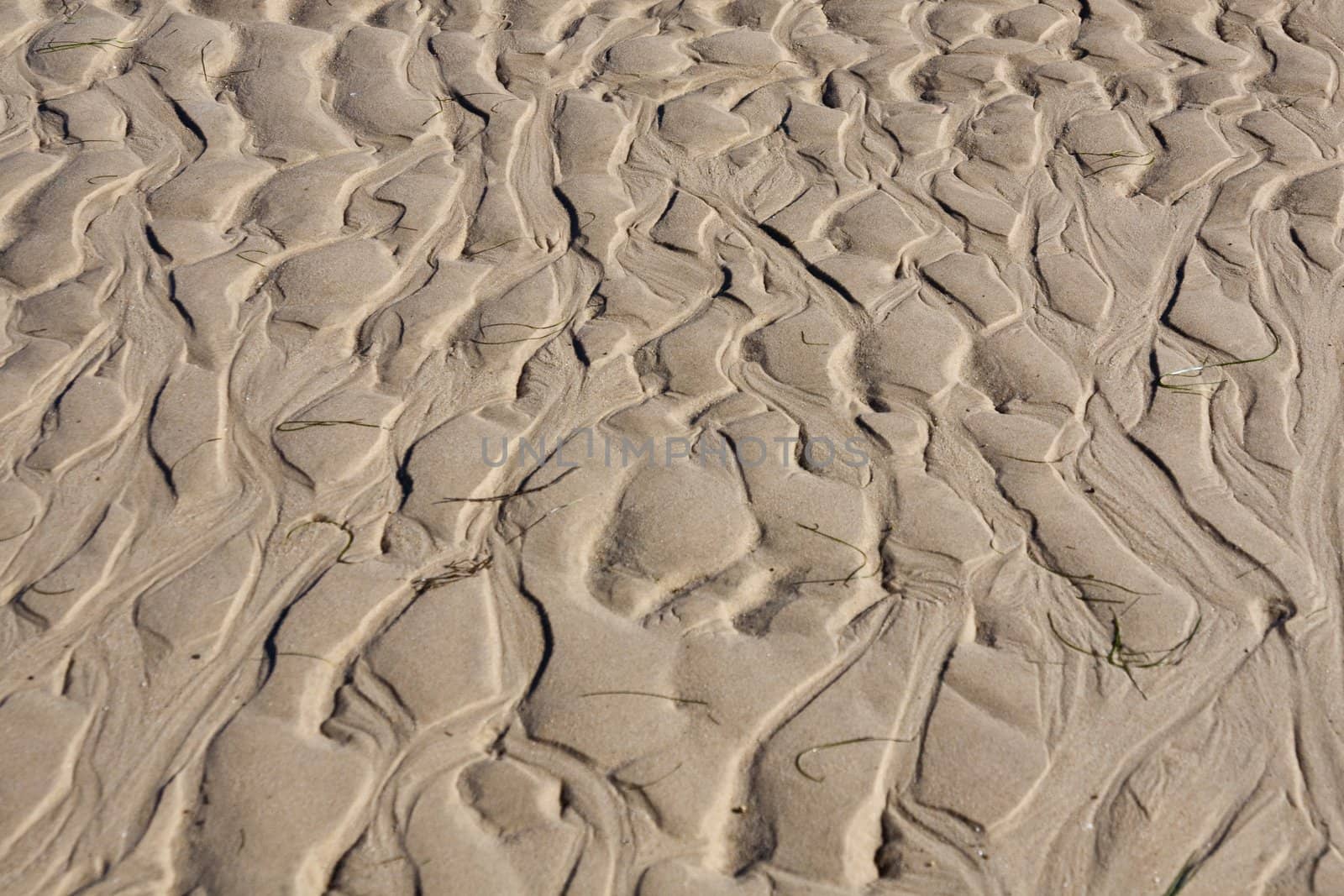 View of natural ripples made by the tide on the sand.