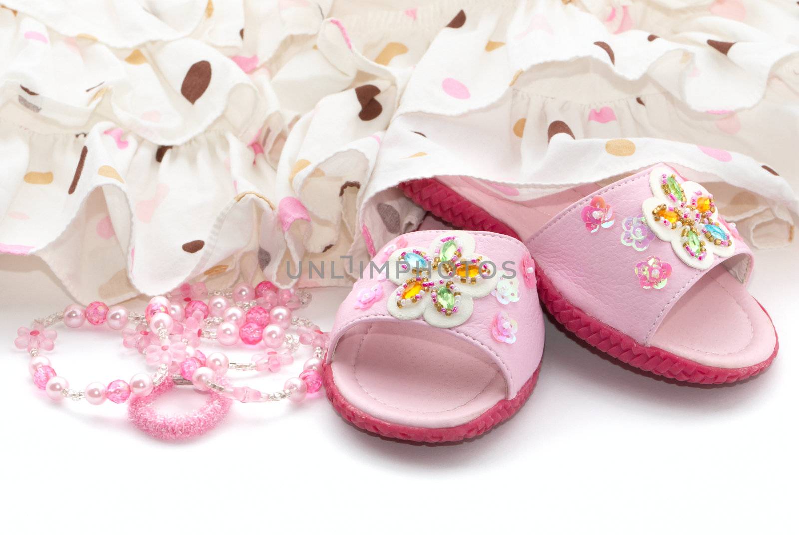 Pink child's shoes and beads