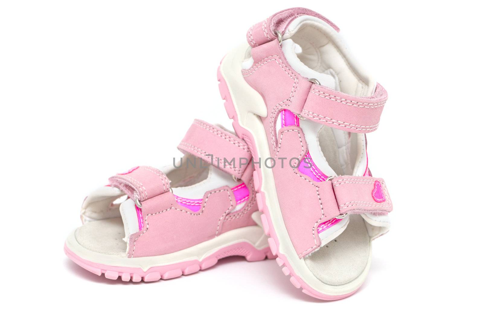 Pink child's sandals isolated on white