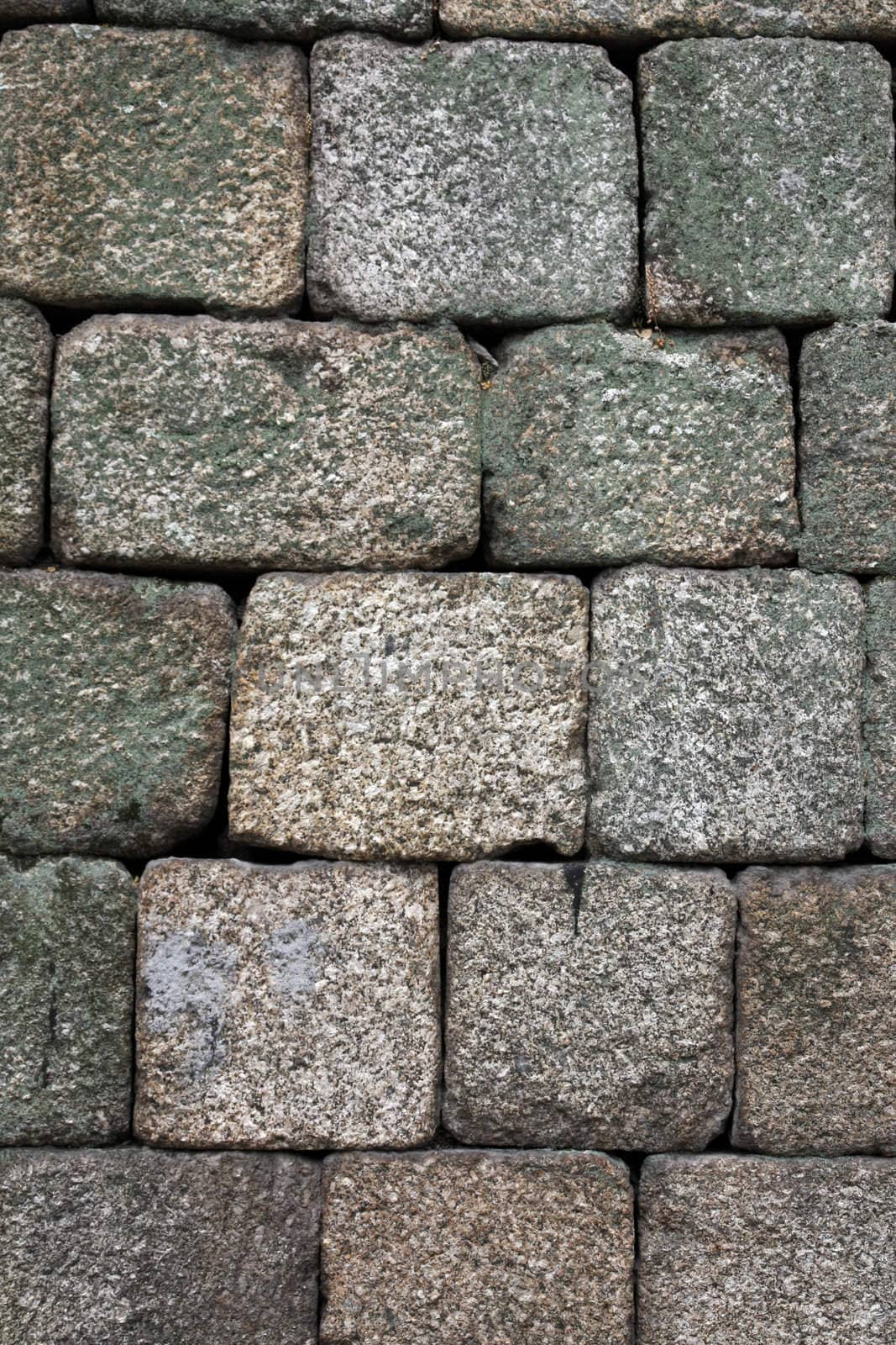 Close view of an old castle textured stone wall.