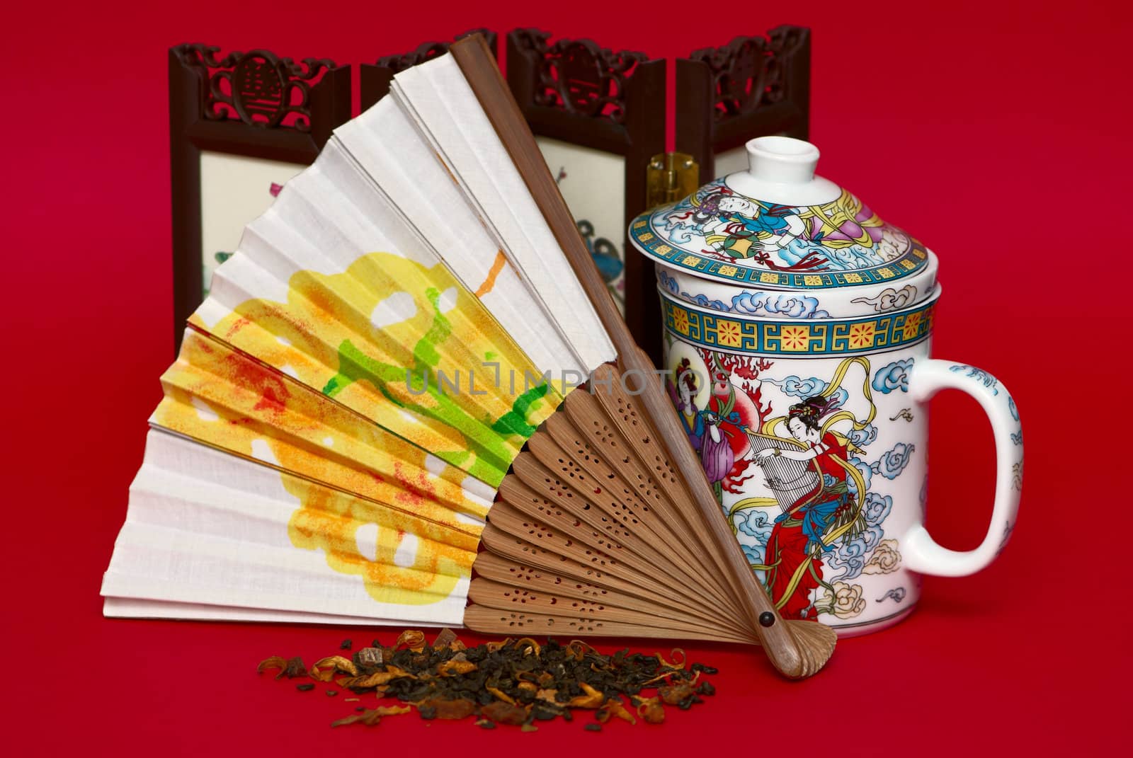 Fan and cup in asian style isolated on red background