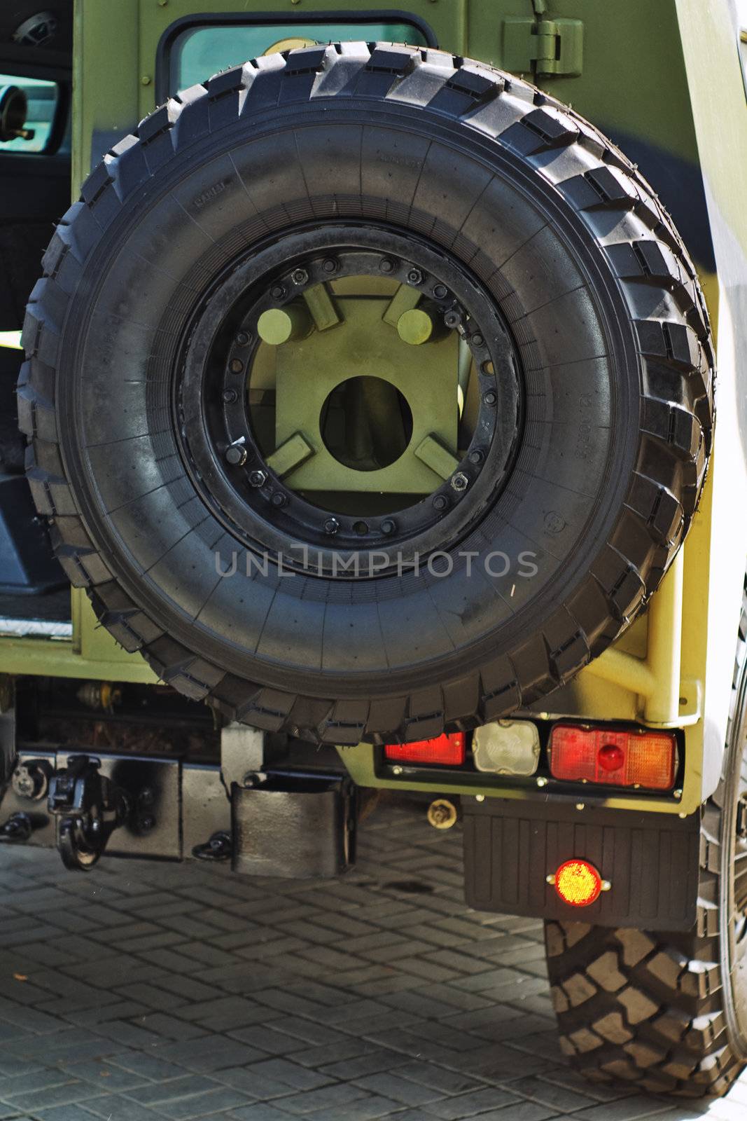 closeup jeep spare wheel behind the car