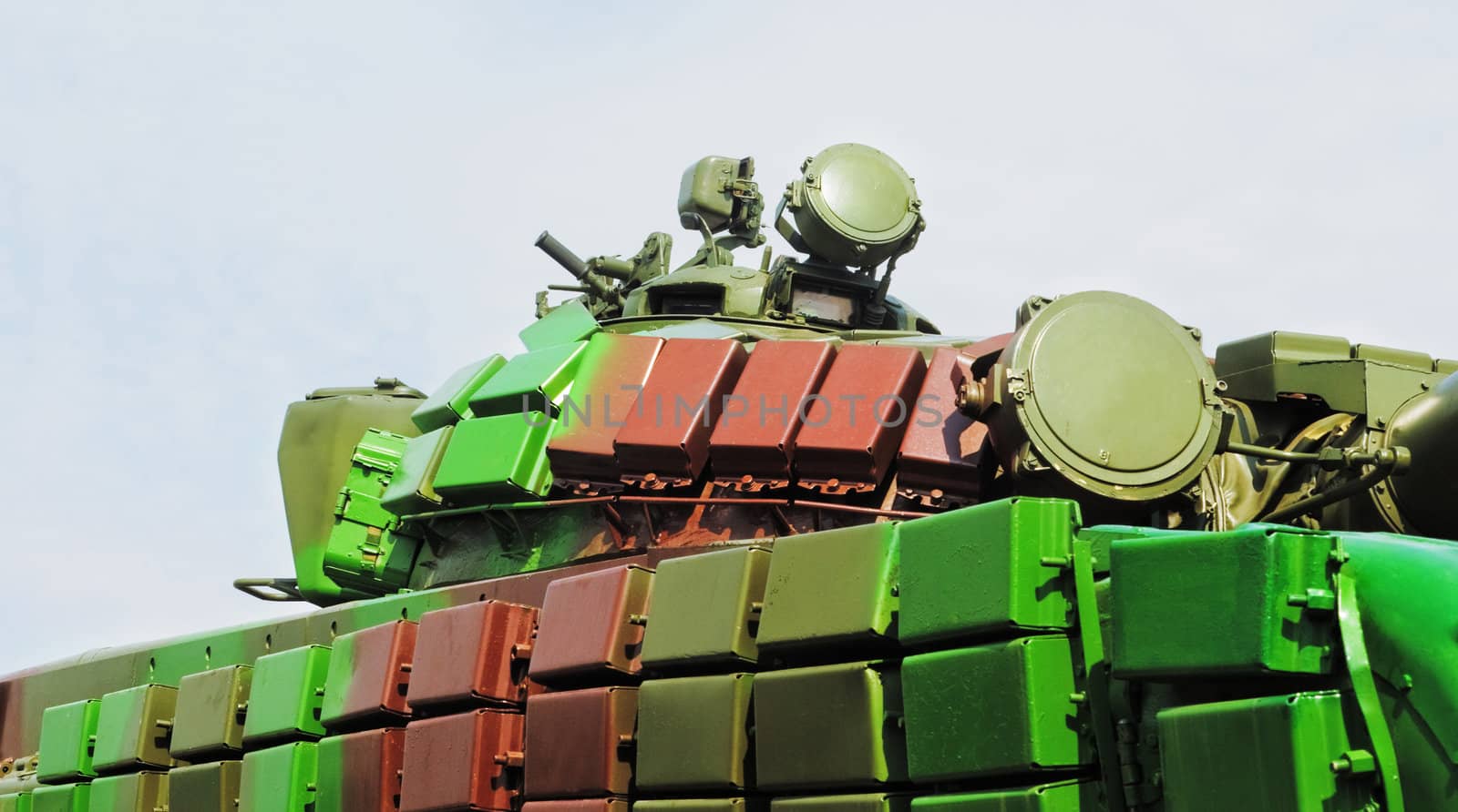 Blocks of active armored protection on the tank painted in light green, green and brown colours