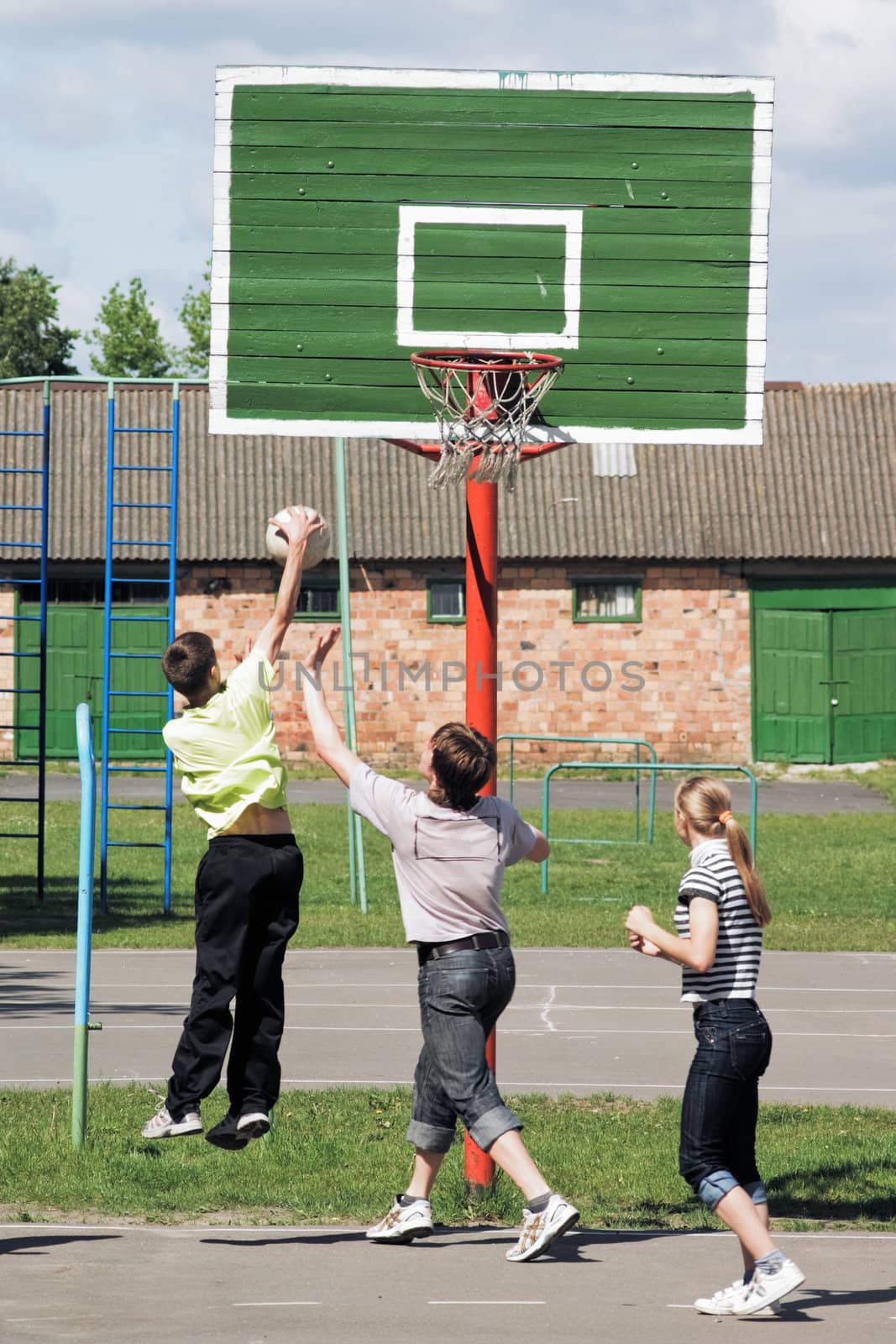 Game in basketball on an athletic field in town houses court yard