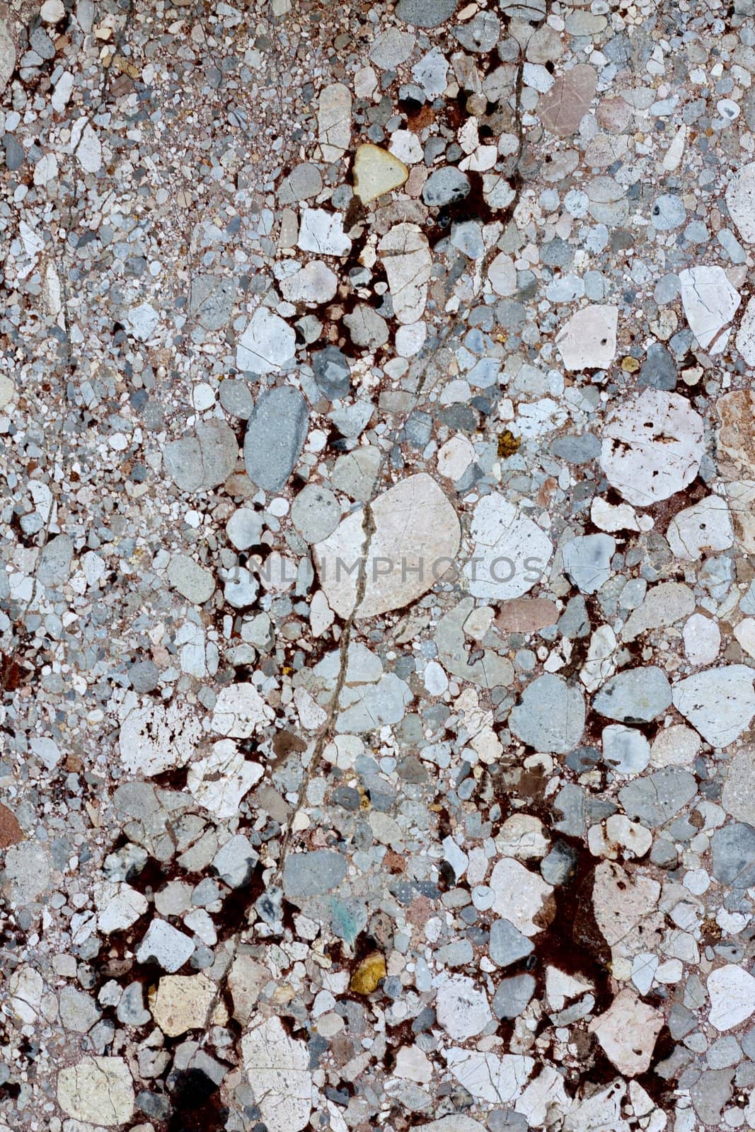 Close up view of a mixed marble textured wall.