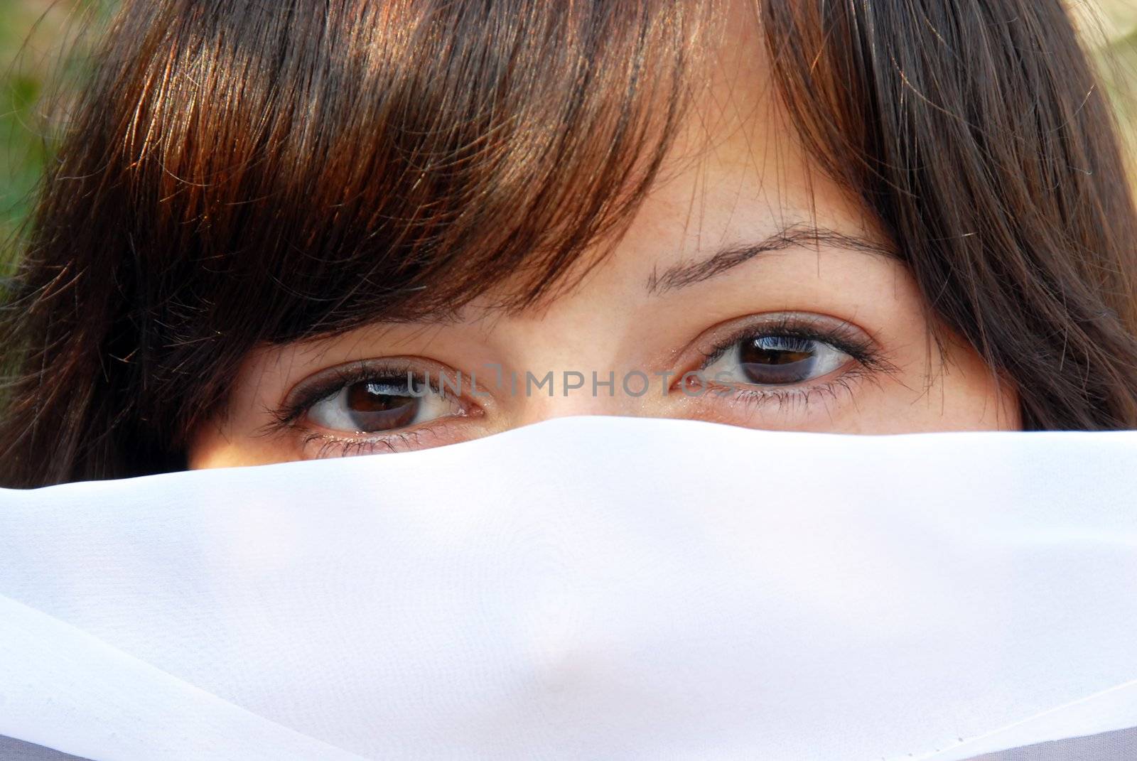 young brunette woman eyes and hair outdoor