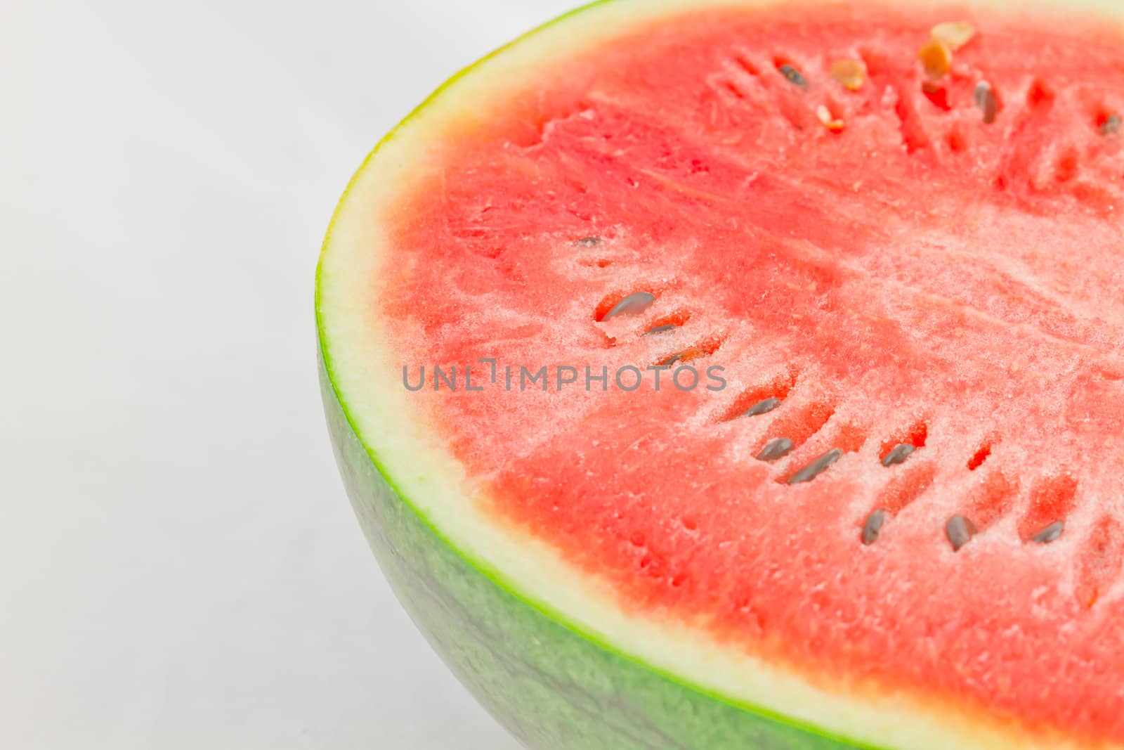 Half cut watermelon on white background.