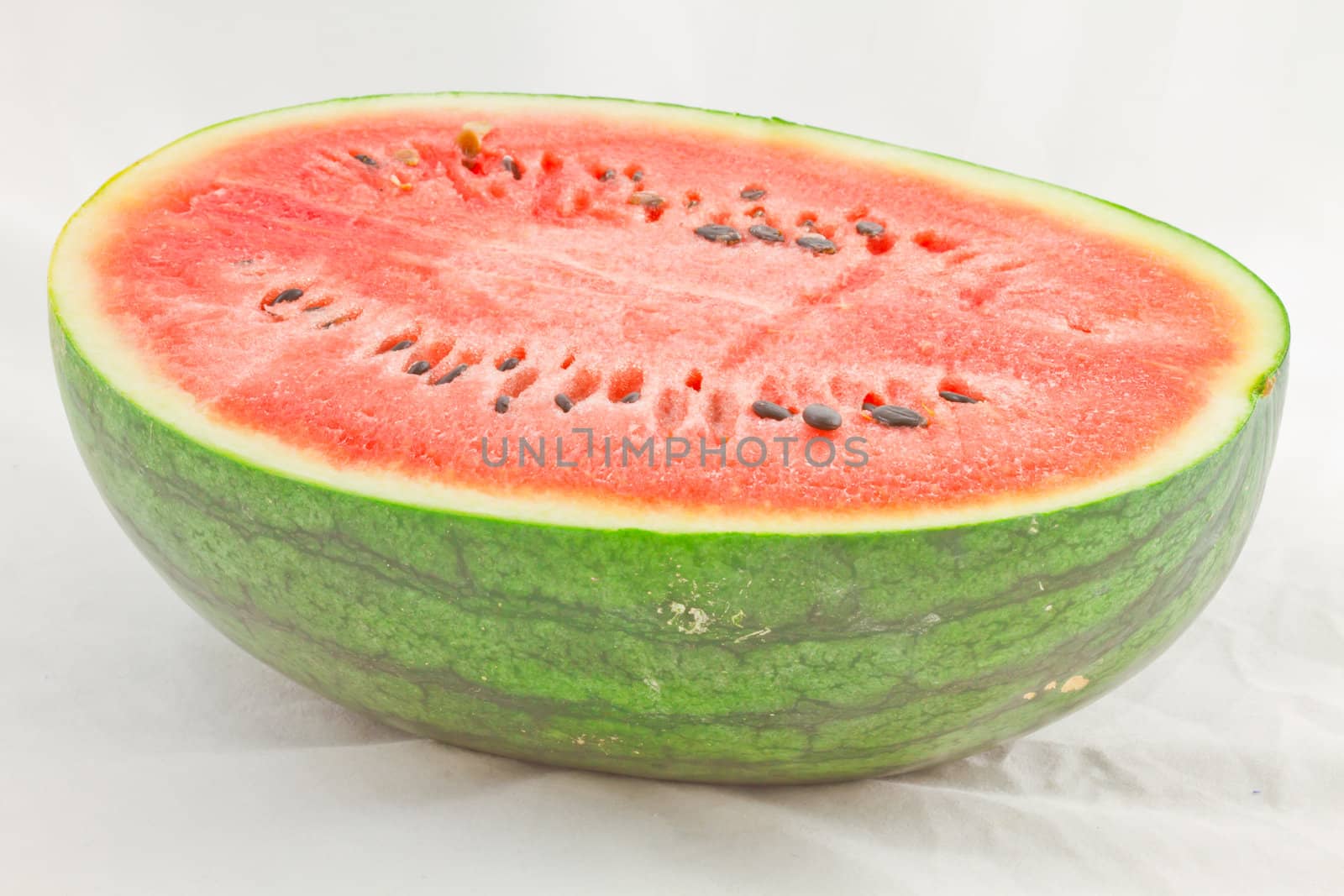 Half cut watermelon on white background.