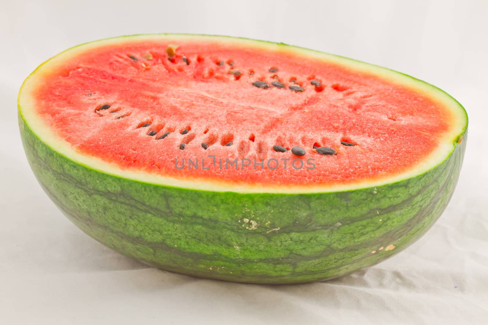 Half cut watermelon on white background.