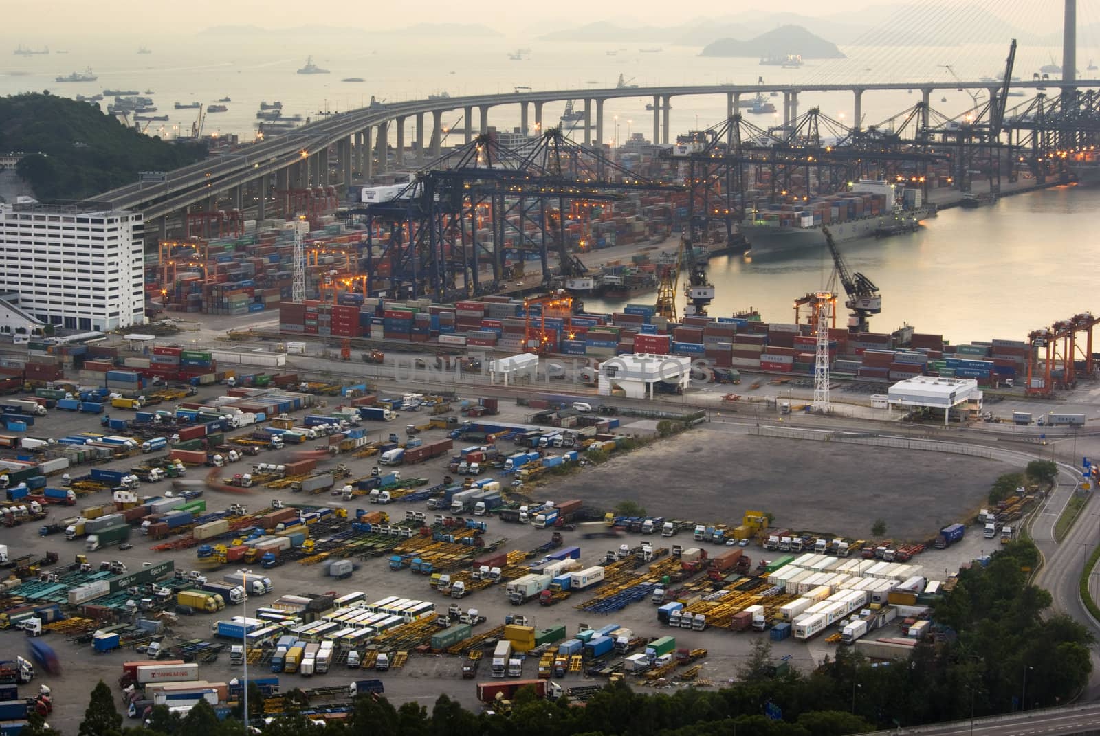 hong kong containers dock and bridge in sunset