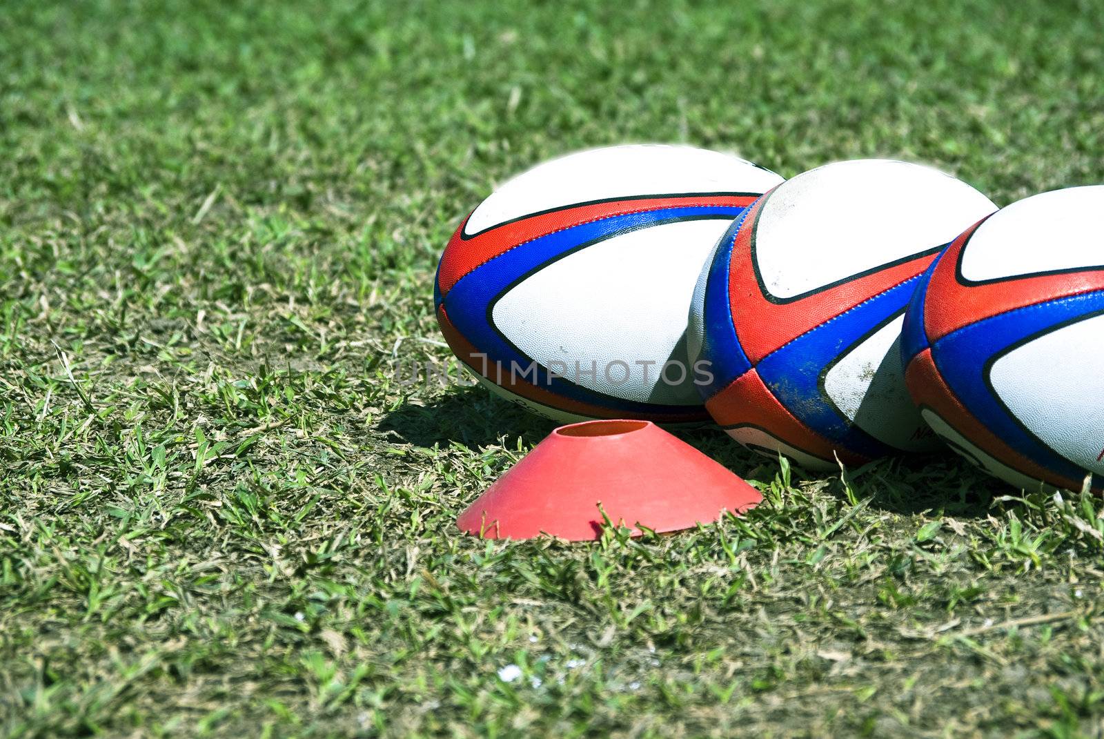 three rugby on the grass for texture