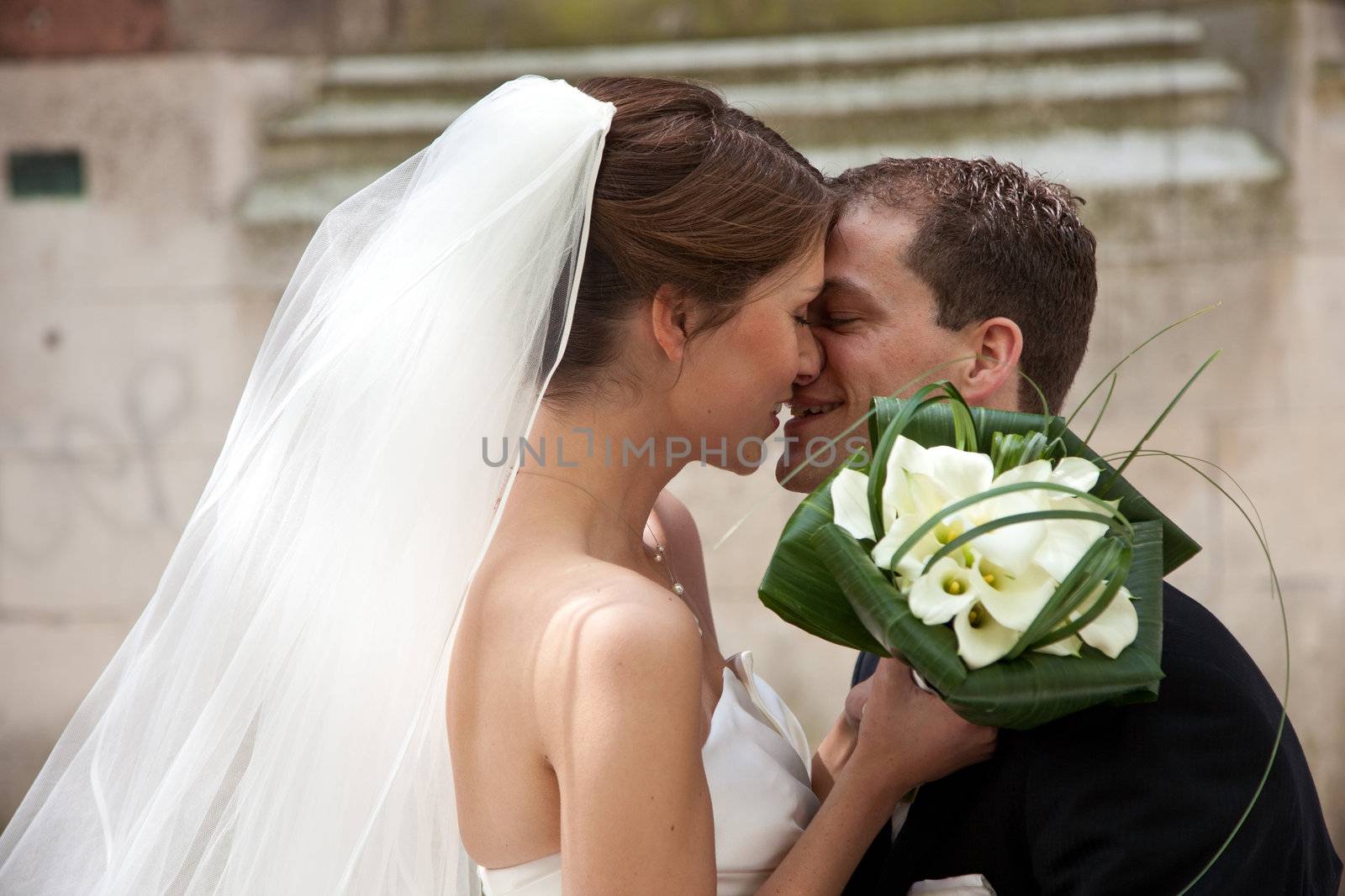 Beautiful bride and groom kissing while doing their photoshoot