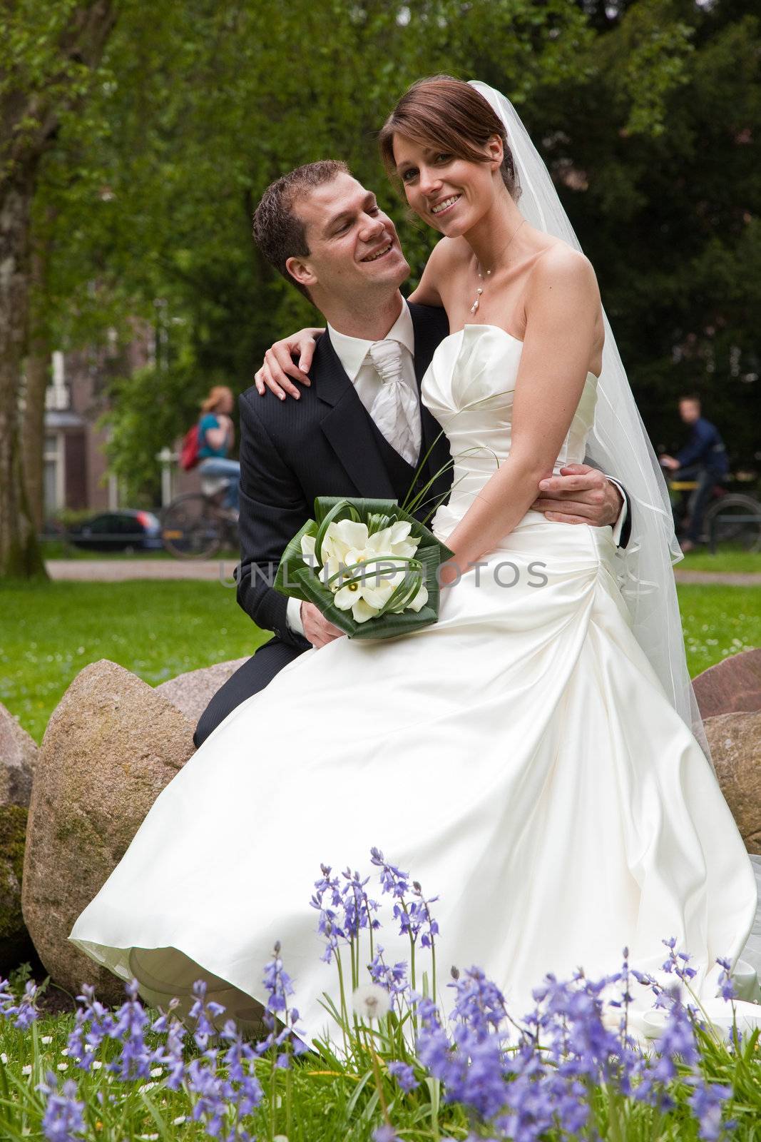 Beautiful bride and groom together in the park looking happy