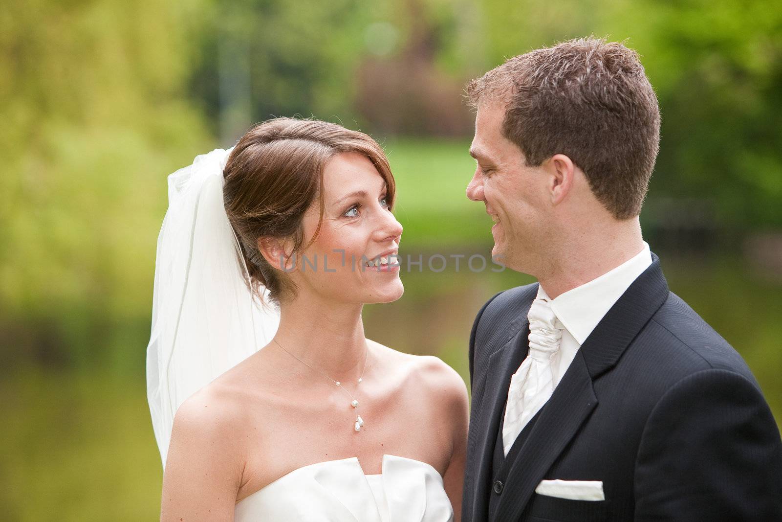 Beautiful bride and groom looking eachother happily in the eyes