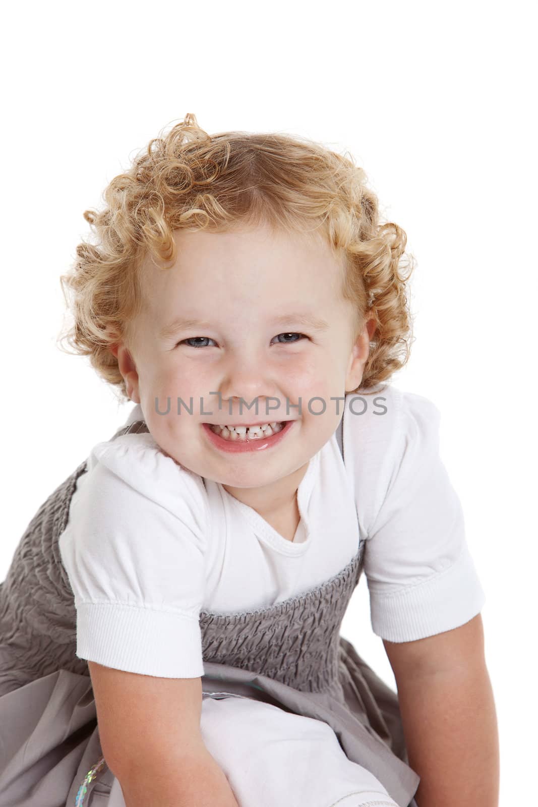 Adorably young girl with a cheeky grin on her face