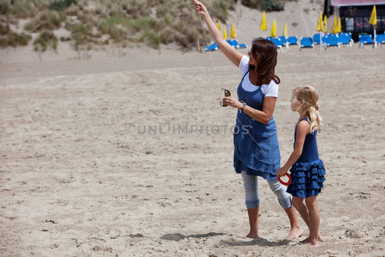 Mother and daughter trying to get a kite into the air