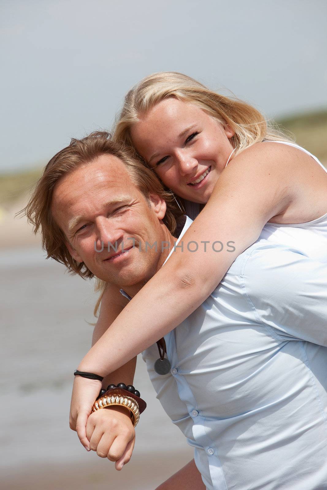 Father and daughter on a summer day doing piggyback ride