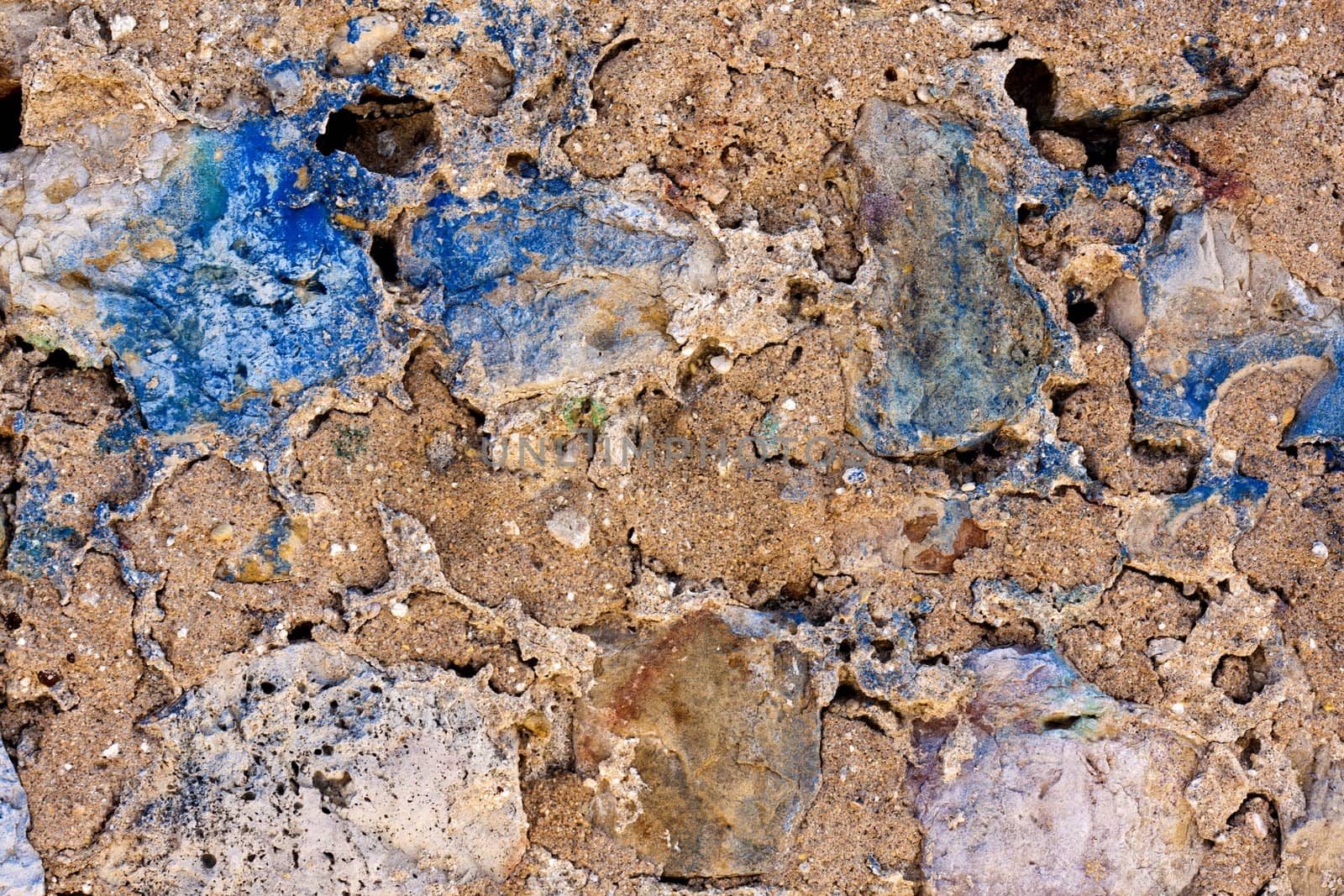 Close up view of a worn textured cement wall.