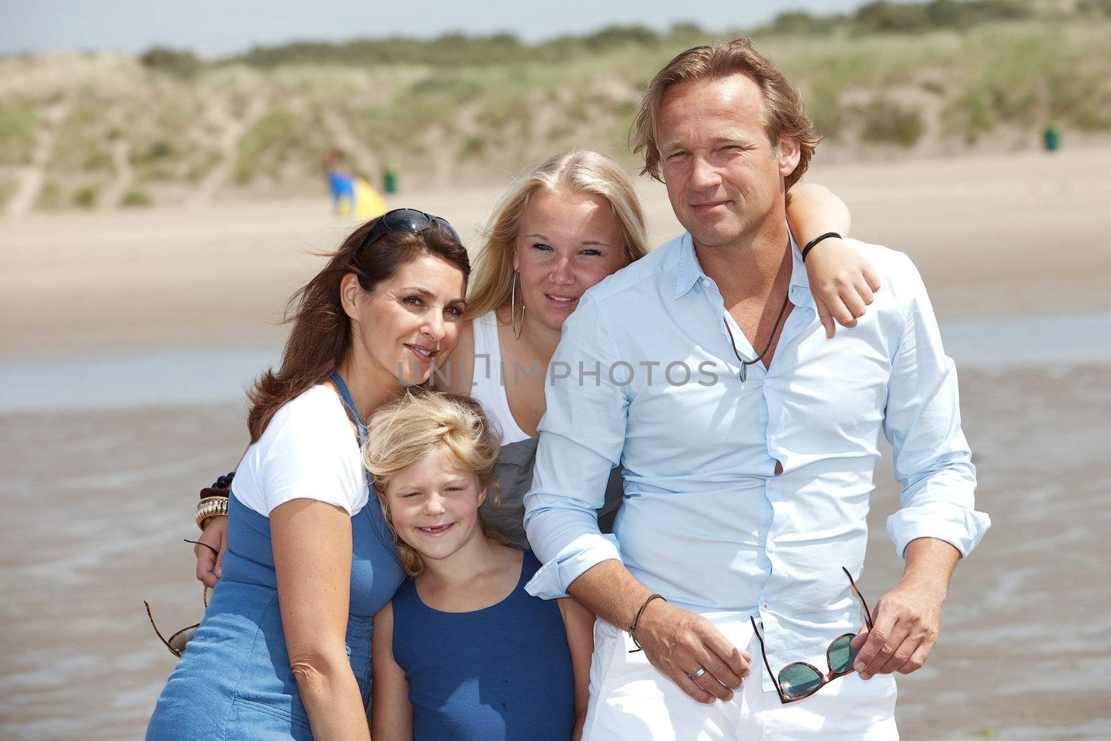 Young attractive family enjoying their summer by the seaside