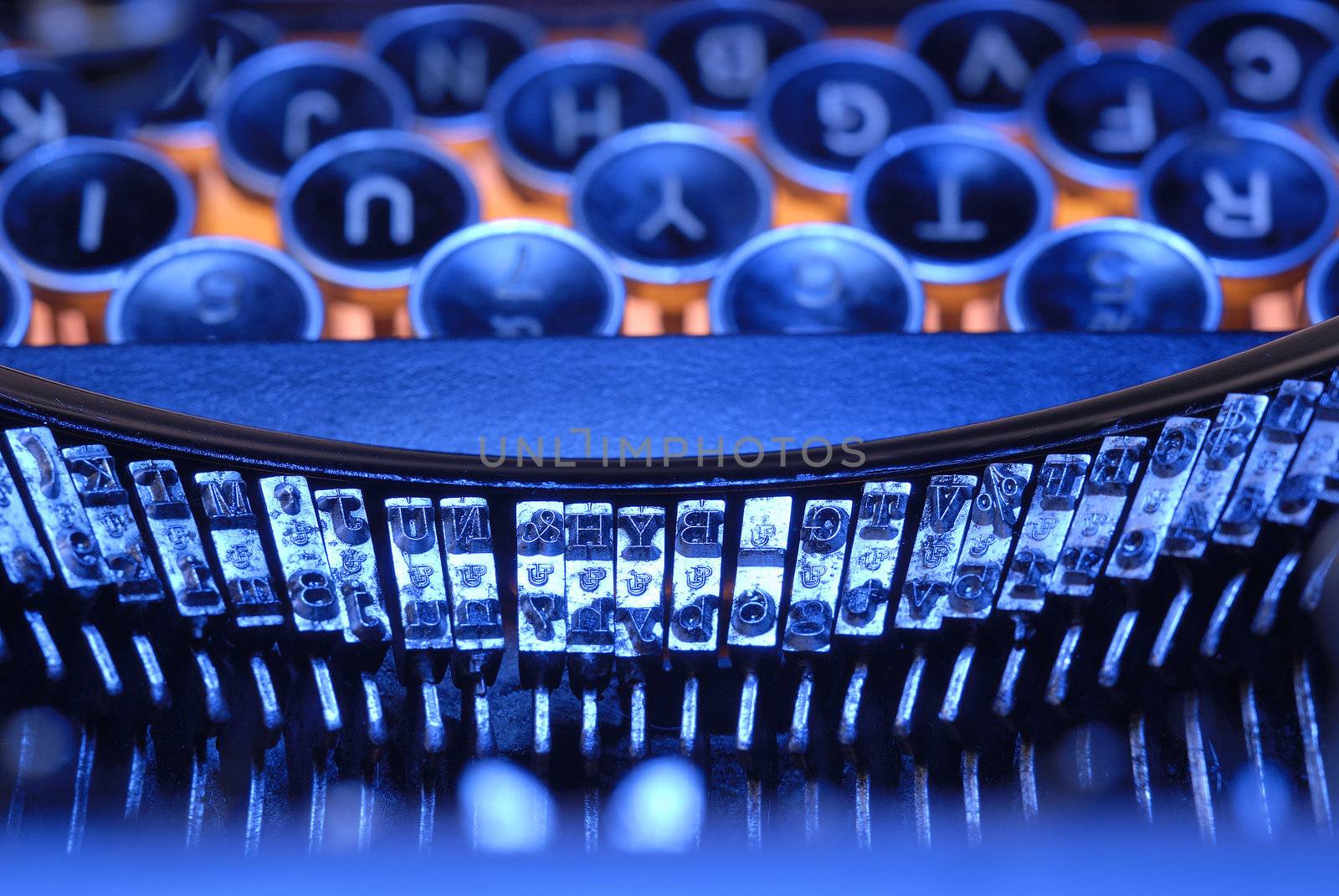 Closeup of old typewriter keys and fonts in blues and orange