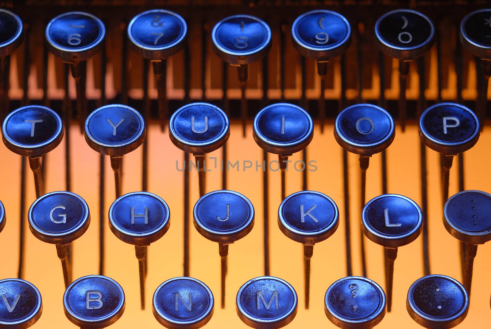 keys from a antique typewriter in blue and orange