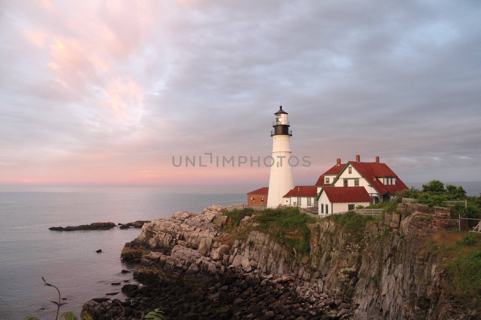 The Portland Head Light with pastel clouds overhead.