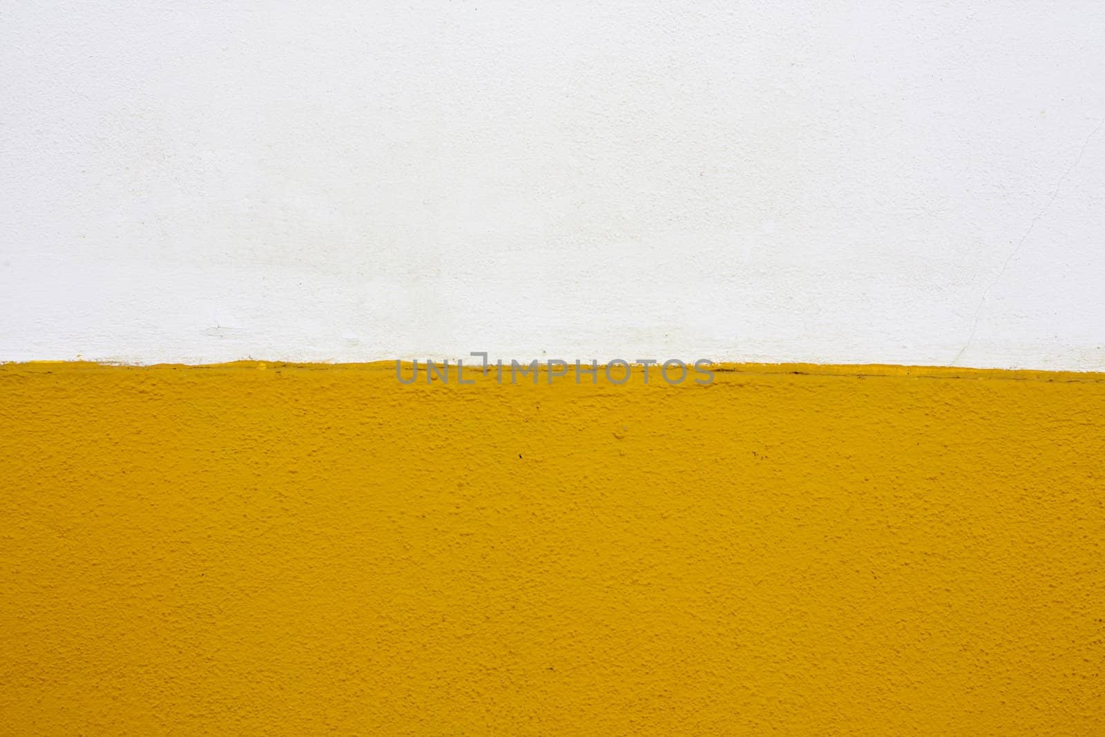 Close up view of a white and yellow wall texture.