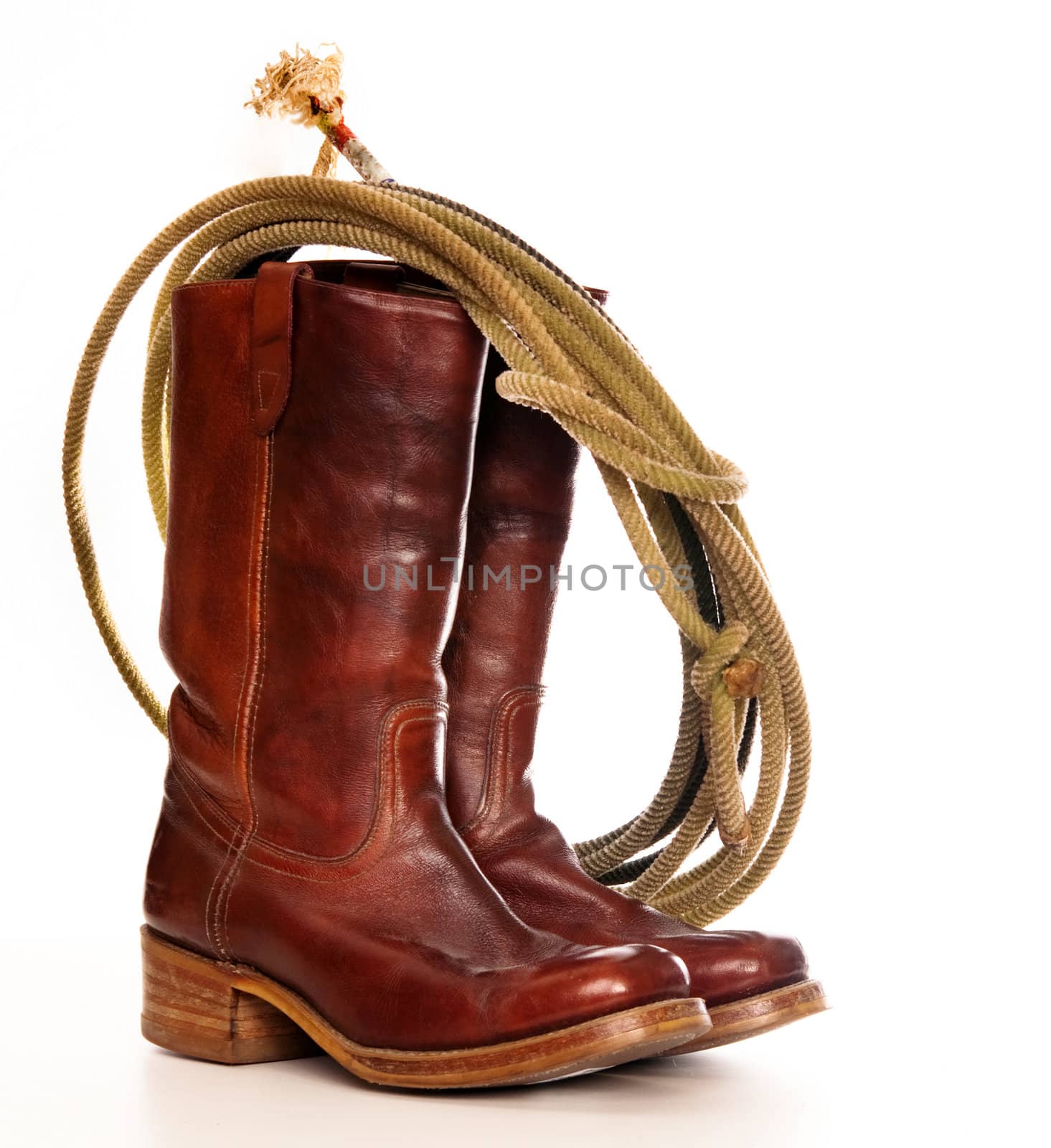 cowboy boots and a Lasso on a white background  by Paulmatthewphoto