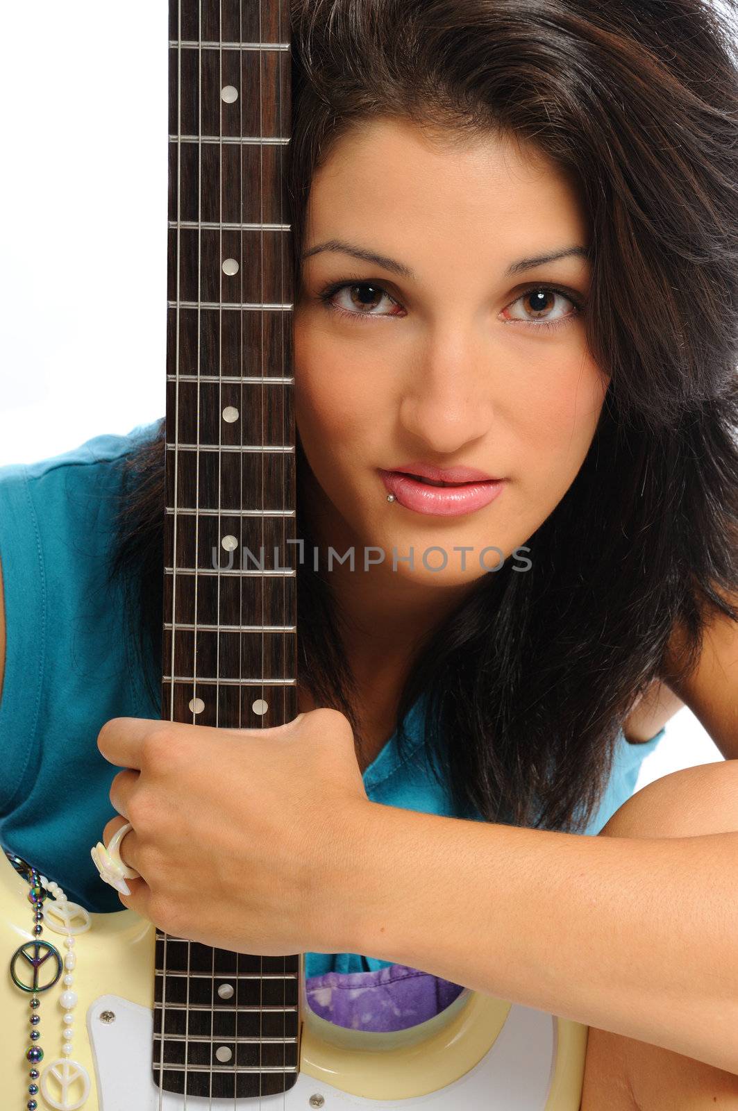 attractive young hispanic woman portrait with a guitar on a white background